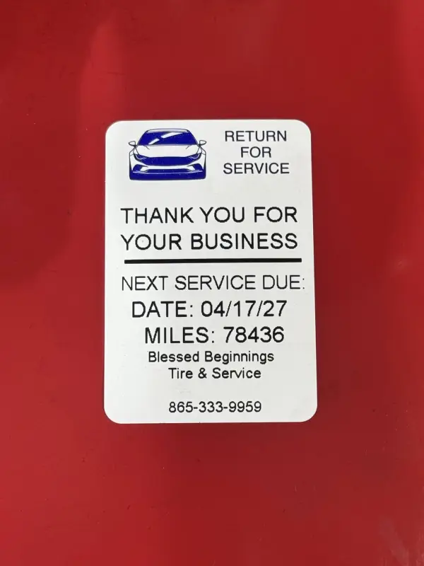 A Blessed Beginnings 'Return for service' reminder sticker showing the next service date and mileage
